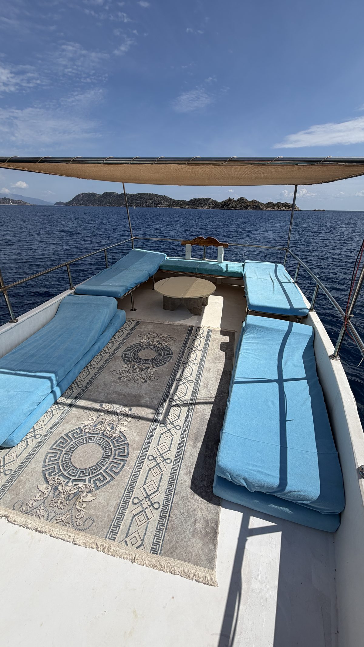 Sun mattresses and a kilim on the upper deck beneath the awning
